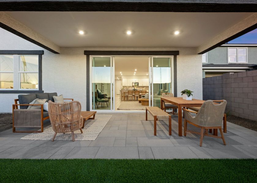 A room with a table chairs and a couch. A room with a table chairs and a couch.