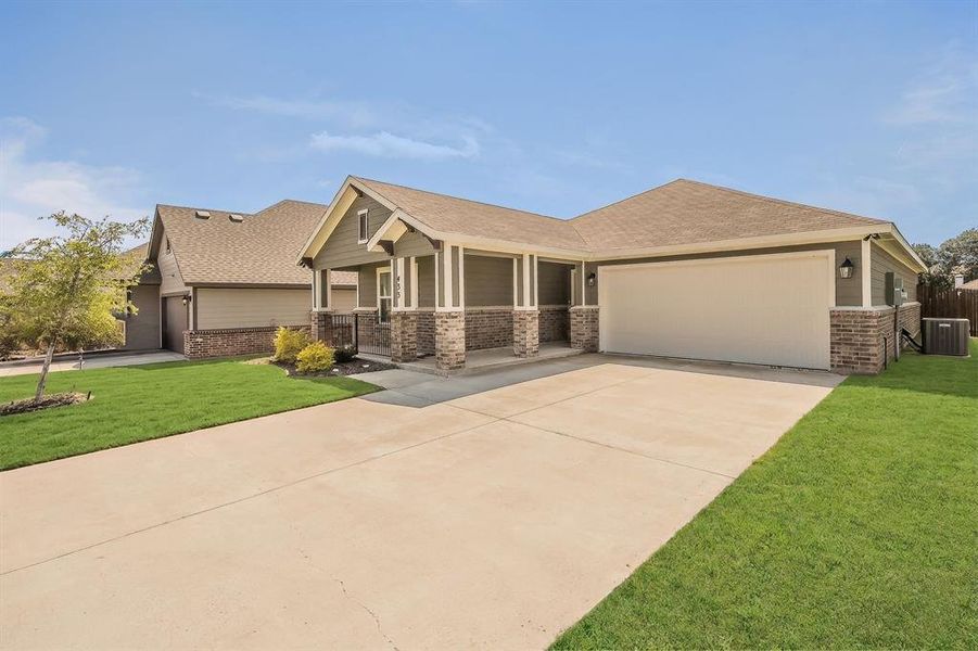 Front exterior of a new home in Craftsman’s Corner, Cleburne, TX, highlighting curb appeal (Image 22).