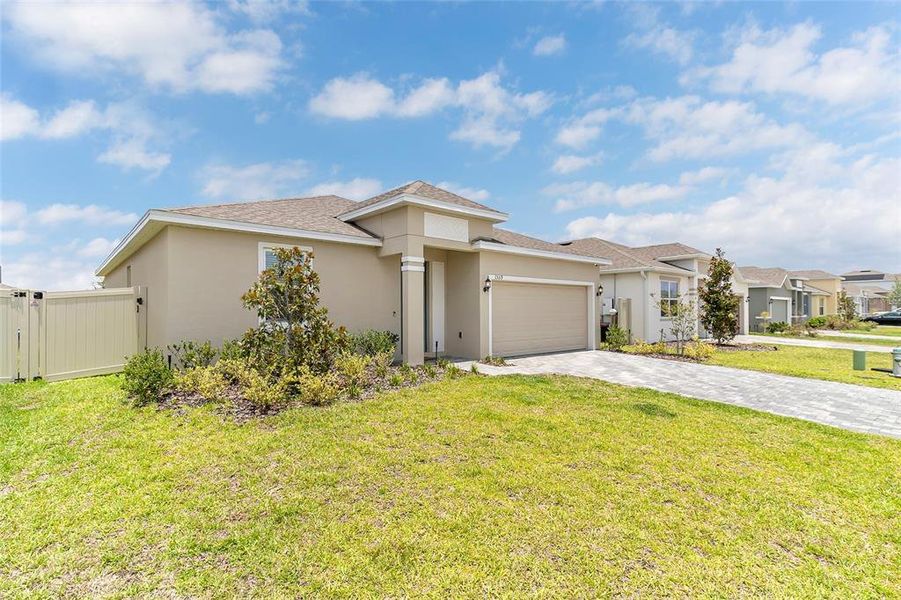 Front exterior of a new home in Tarpon Bay, Haines City, FL, highlighting curb appeal (Image 24). Front exterior of a new home in Tarpon Bay, Haines City, FL, highlighting curb appeal (Image 24).
