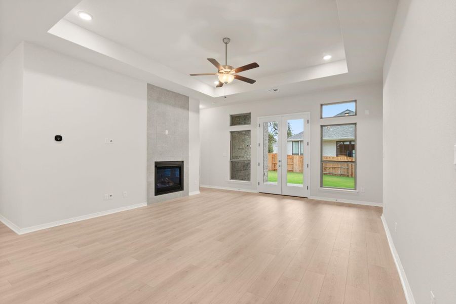 Family Room with Tray Ceilings and Fireplace