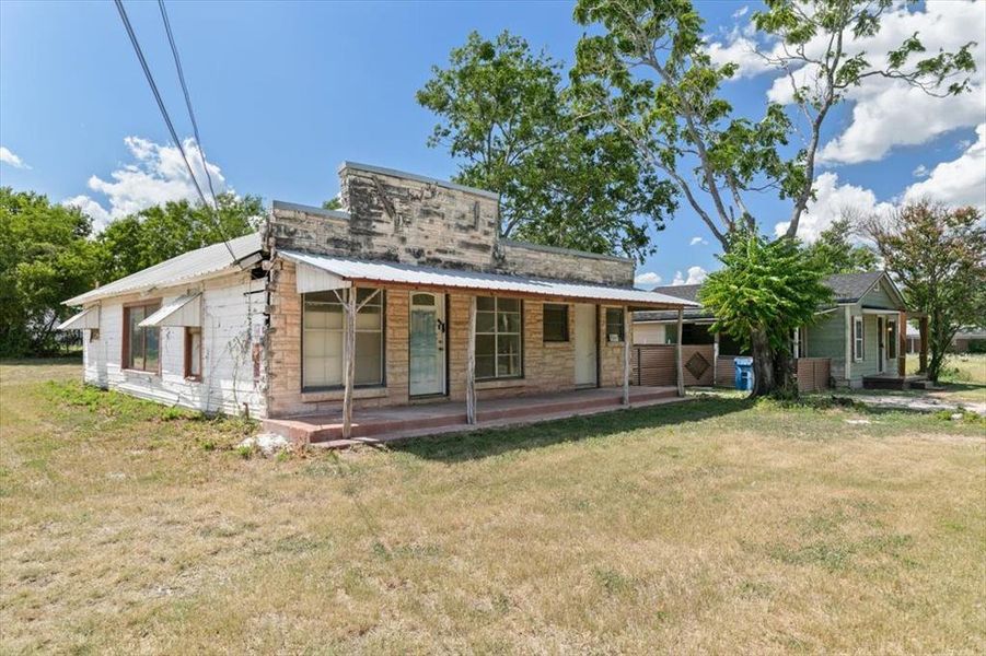 Rear view of house featuring a lawn Rear view of house featuring a lawn