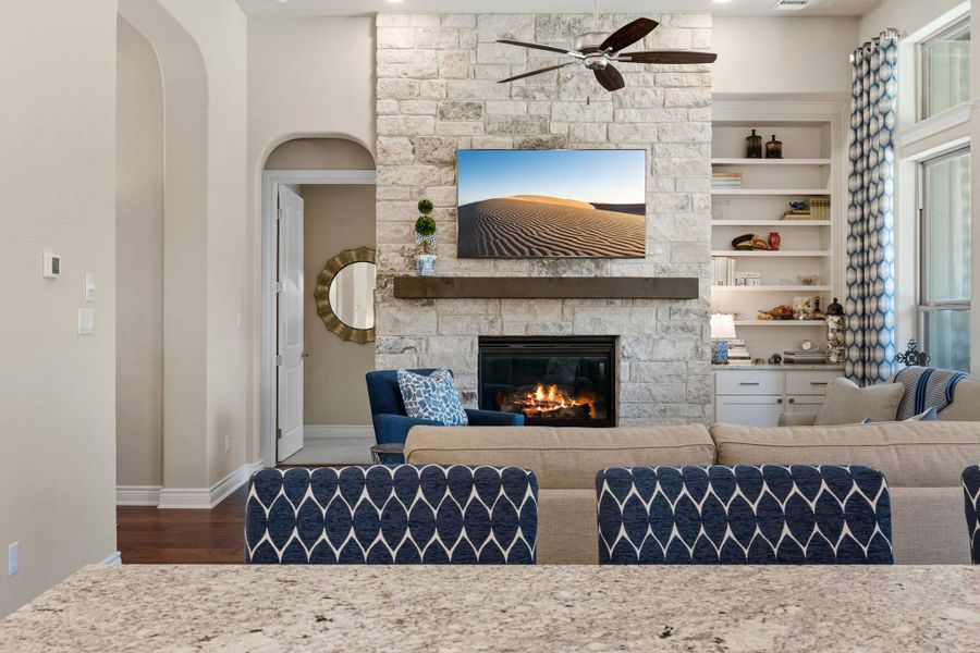 The floor-to-ceiling stone fireplace creates a striking focal point for the room. The floor-to-ceiling stone fireplace creates a striking focal point for the room.