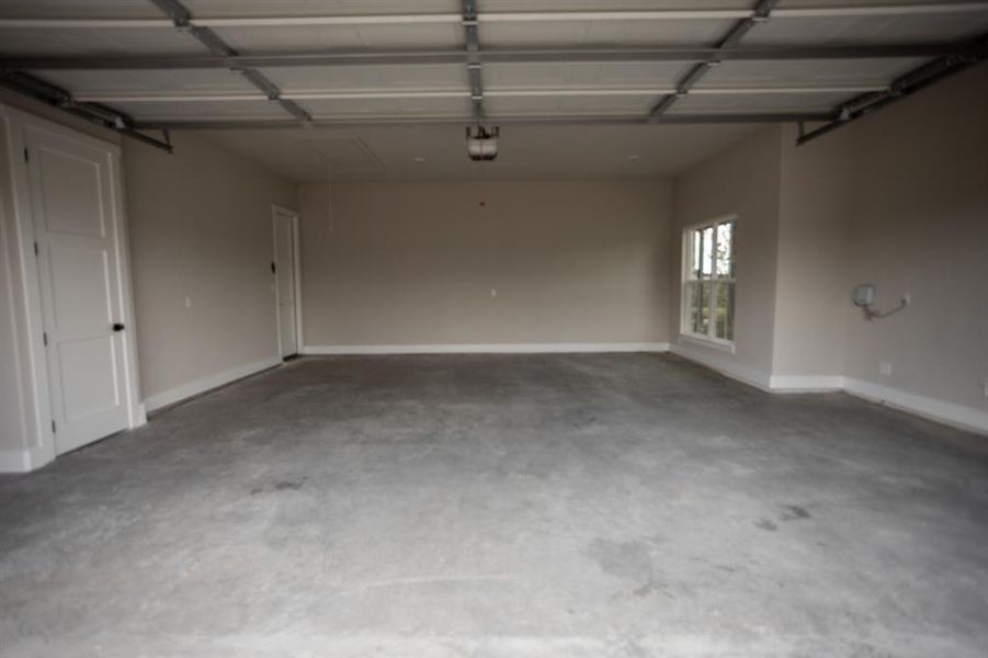 Garage featuring baseboards Garage featuring baseboards