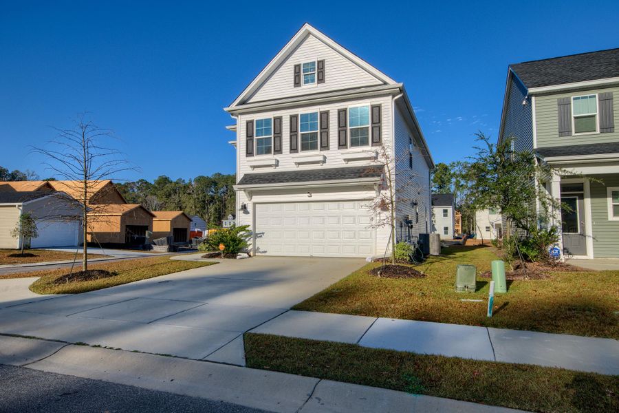 Front exterior of a new home in Six Oaks, Summerville, SC, highlighting curb appeal (Image 28). Front exterior of a new home in Six Oaks, Summerville, SC, highlighting curb appeal (Image 28).