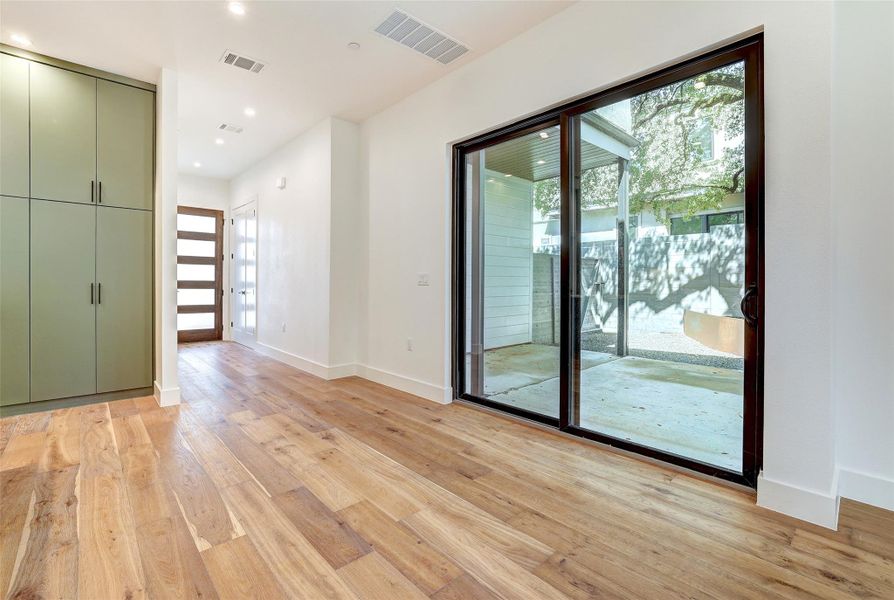 Empty room with light wood-type flooring, baseboards, and recessed lighting