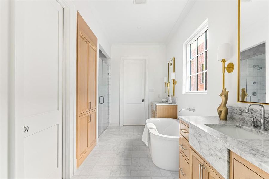 Full bathroom featuring a soaking tub, two vanities, and a shower stall Full bathroom featuring a soaking tub, two vanities, and a shower stall