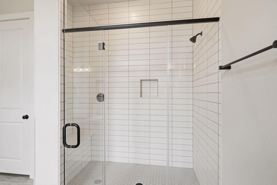 A large walk-in shower sits next to a generous walk-in closet, providing a seamless, organized space for your daily morning routine