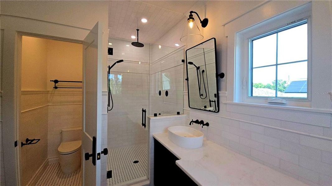 Primary Bath with shower and multiple heads and private toilet