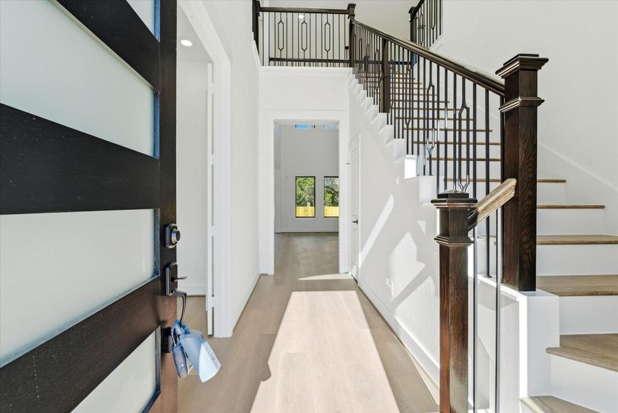 From the moment you enter, you’re welcomed by dramatic 21-foot ceilings, luxury vinyl floors, and a private office thoughtfully placed to the left.