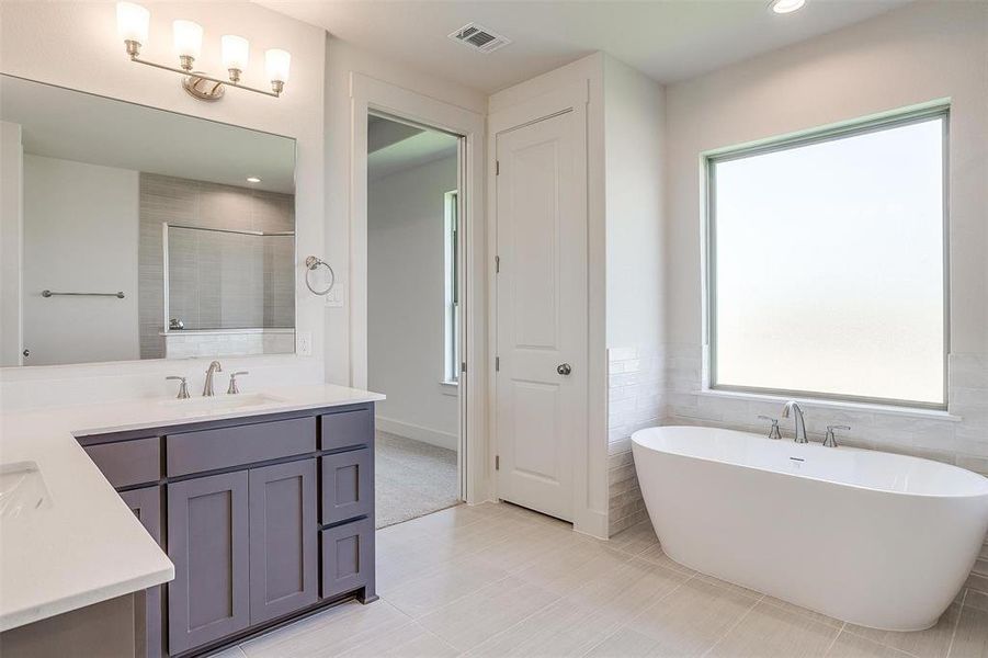 Bathroom featuring tile flooring and large vanity