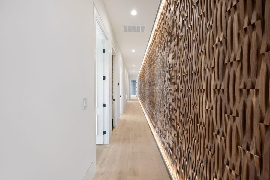 Artistic wood paneling creates a captivating visual journey along this elegant hallway. Artistic wood paneling creates a captivating visual journey along this elegant hallway.