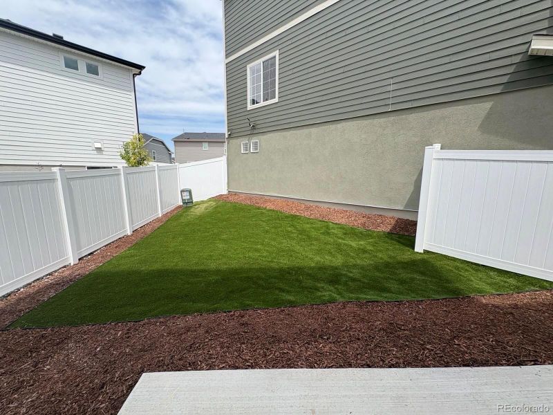 Front exterior of a new home in Green Valley Ranch, Aurora, CO, highlighting curb appeal (Image 27).