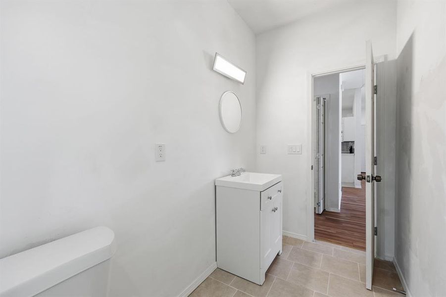 Full bathroom with light tile patterned floors and vanity
