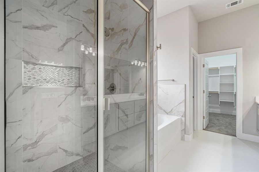 Oversized soaking tub and beautiful shower enclosure