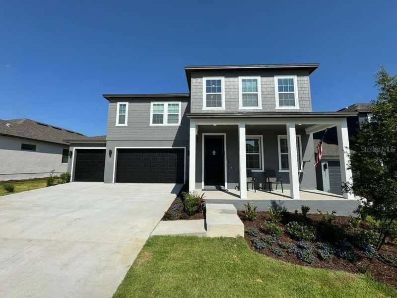 Front exterior of a new home in , Minneola, FL, highlighting curb appeal (Image 18). Front exterior of a new home in , Minneola, FL, highlighting curb appeal (Image 18).