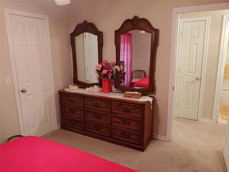 Carpeted room featuring a white paneled door and light-colored walls
