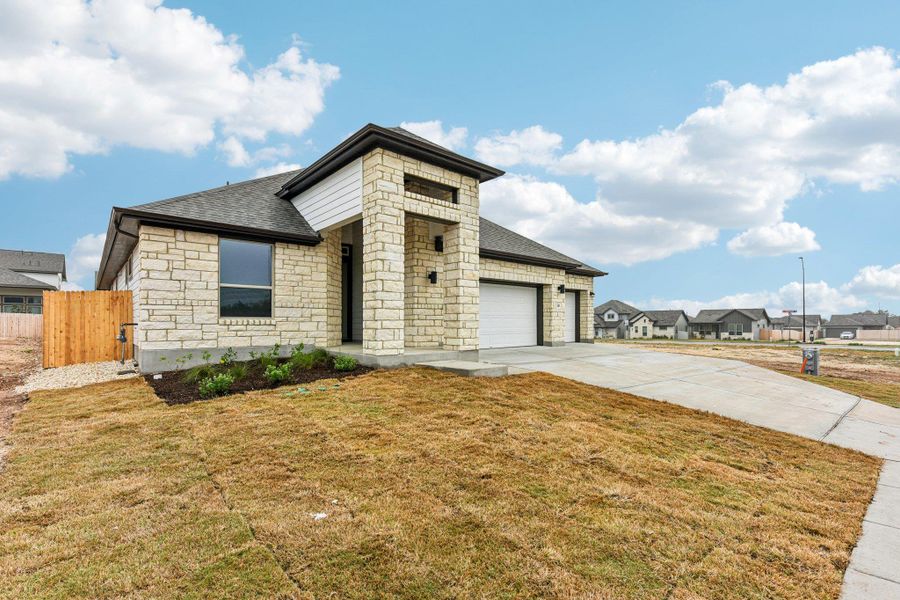 Front exterior of a new home in Sage Hollow, Kyle, TX, highlighting curb appeal (Image 1). Front exterior of a new home in Sage Hollow, Kyle, TX, highlighting curb appeal (Image 1).