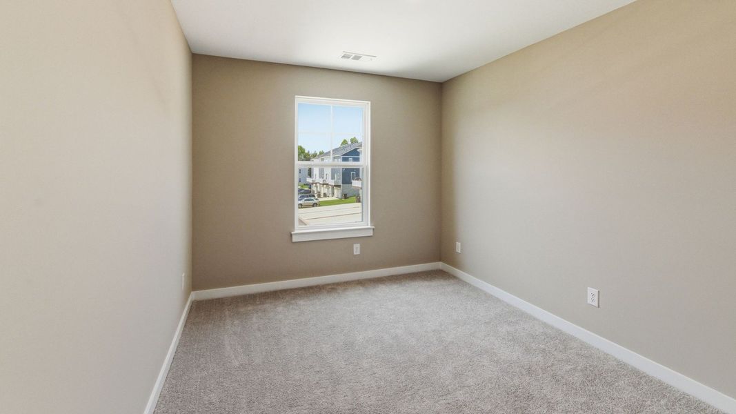 Bedroom with carpet and window