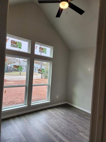 Additional living space with hardwood / wood-style floors, ceiling fan, and lofted ceiling