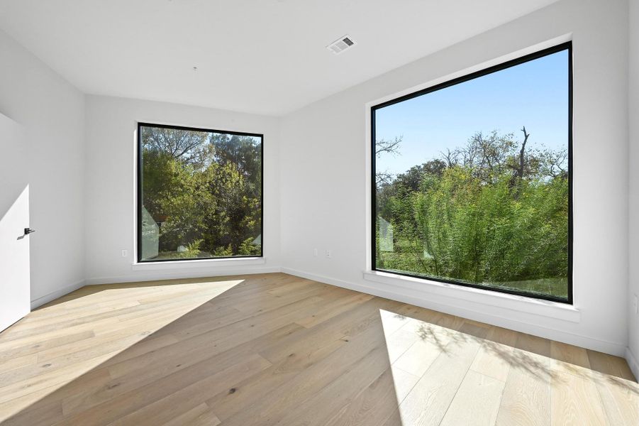 Empty room featuring light wood-style flooring and baseboards Empty room featuring light wood-style flooring and baseboards