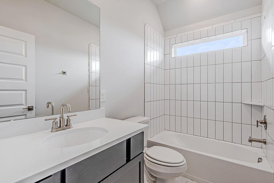 Secondary bath featuring clean tile work and contemporary fixtures. Secondary bath featuring clean tile work and contemporary fixtures.