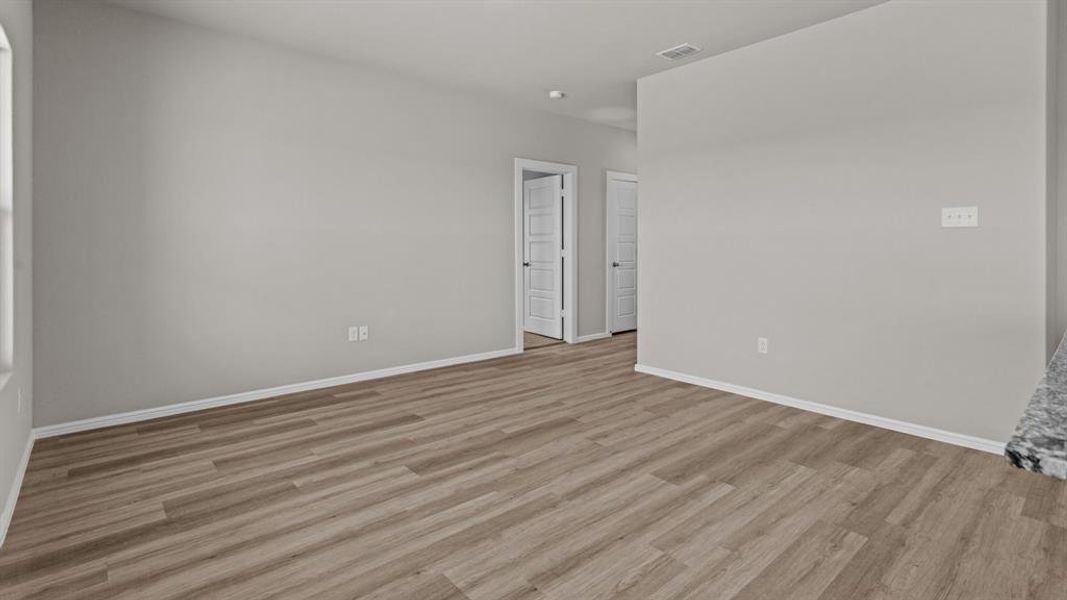 Spare room with light wood finished floors and baseboards Spare room with light wood finished floors and baseboards