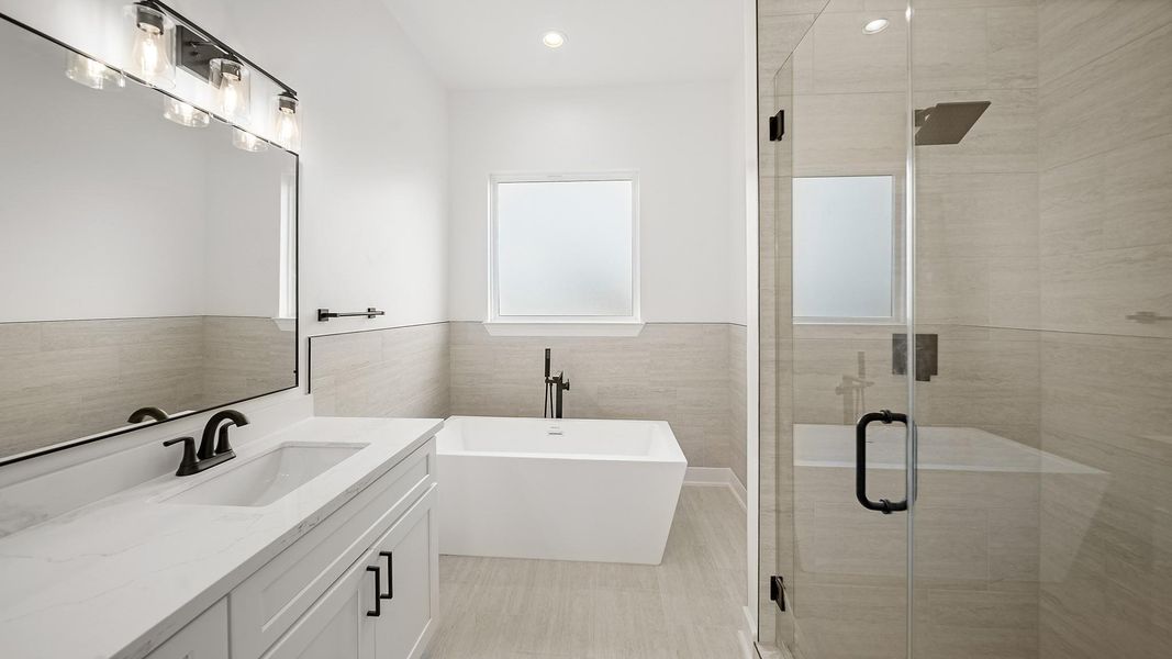 It is complete with a walk-in shower, and a stand alone tub with a privacy frozen glass.