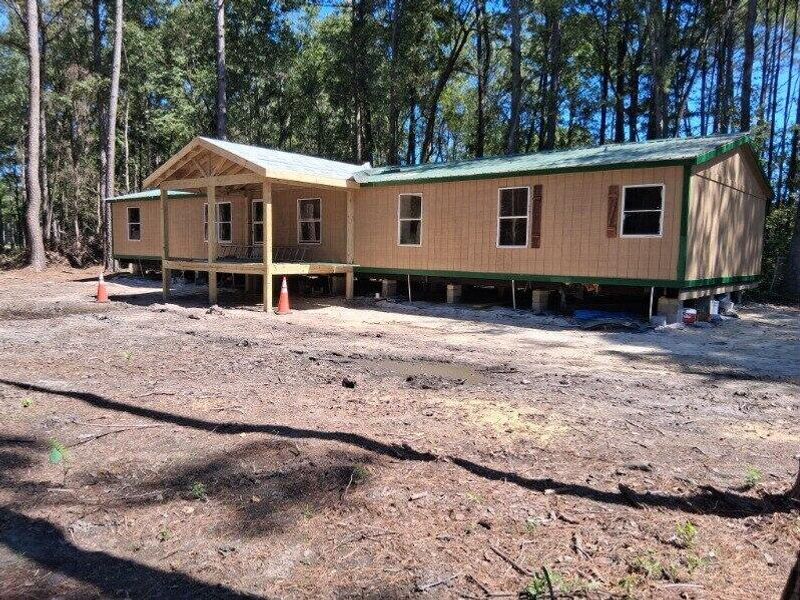 Front exterior of a new home in , Ridgeville, SC, highlighting curb appeal (Image 1).