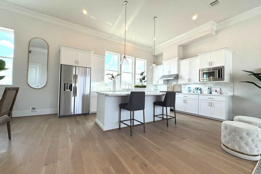 Bright kitchen bathed in natural light.  Refrigerator added virtually.