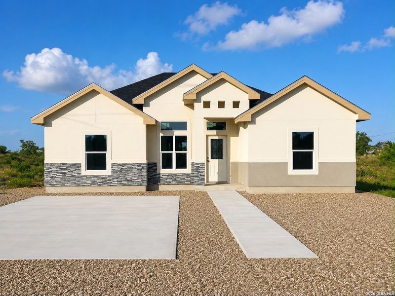 Front exterior of a new home in , Eagle Pass, TX, highlighting curb appeal (Image 2). Front exterior of a new home in , Eagle Pass, TX, highlighting curb appeal (Image 2).