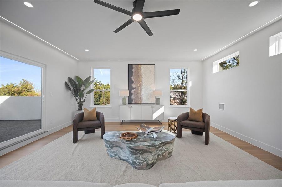 Living area featuring ceiling fan and light wood-type flooring