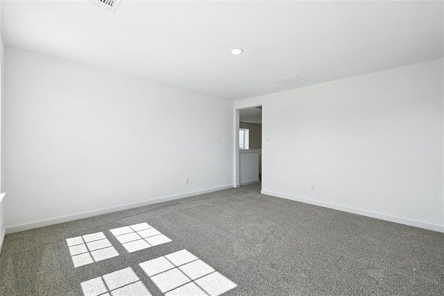 Unfurnished room featuring carpet flooring and baseboards Unfurnished room featuring carpet flooring and baseboards
