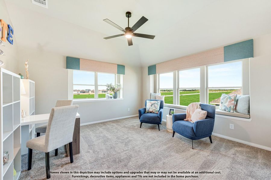 Carpeted flex room with ceiling fan, blue accent chairs, window seat, and large windows with open views outside. Carpeted flex room with ceiling fan, blue accent chairs, window seat, and large windows with open views outside.