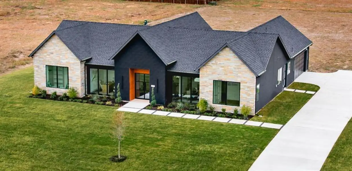 Front exterior of a new home in , Venus, TX, highlighting curb appeal (Image 1).