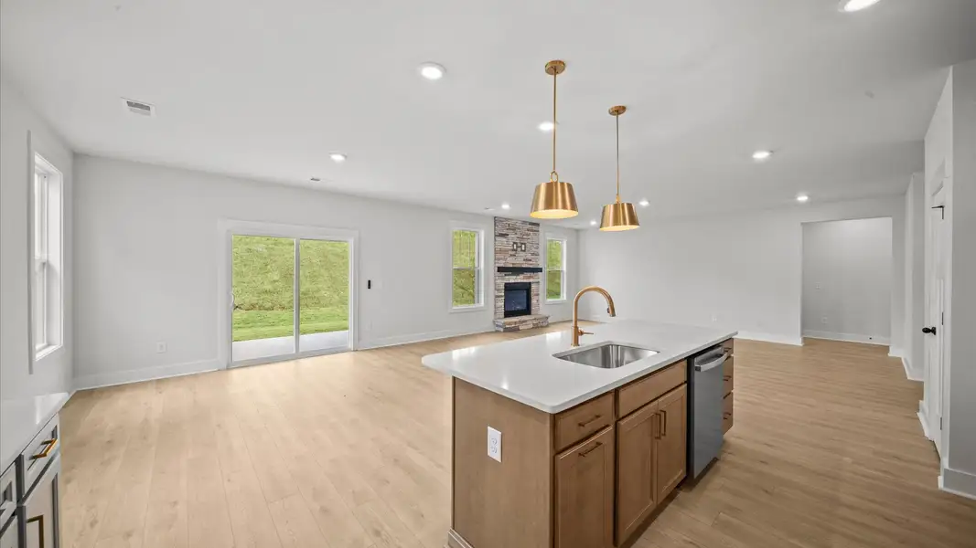 Accomplished kitchen design featuring pendant lighting above a statement island for both prep and gathering