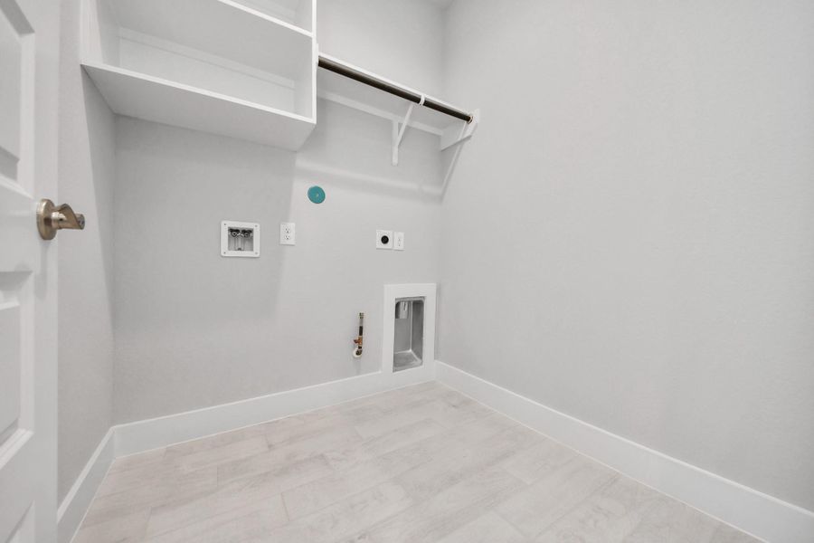 A perfect blend of functionality and comfort. Capture the essence of easy living with a first-floor laundry room, thoughtfully equipped with shelving for effortless organization. Both electric and gas connections available.