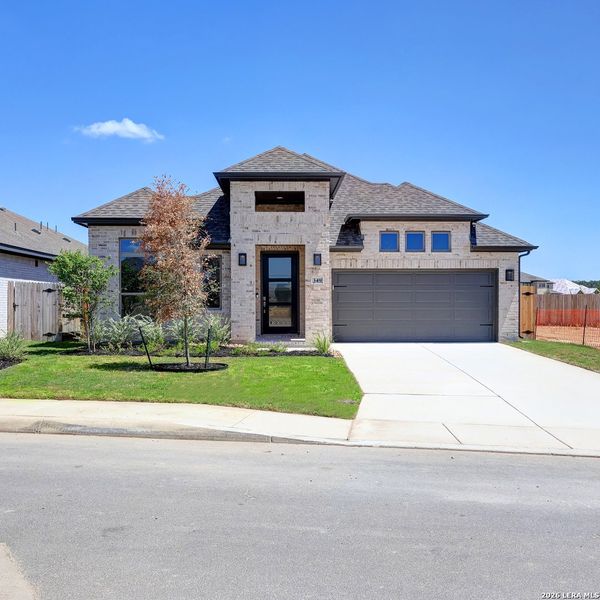 Front exterior of a new home in Alsatian Oaks, Castroville, TX, highlighting curb appeal (Image 2). Front exterior of a new home in Alsatian Oaks, Castroville, TX, highlighting curb appeal (Image 2).