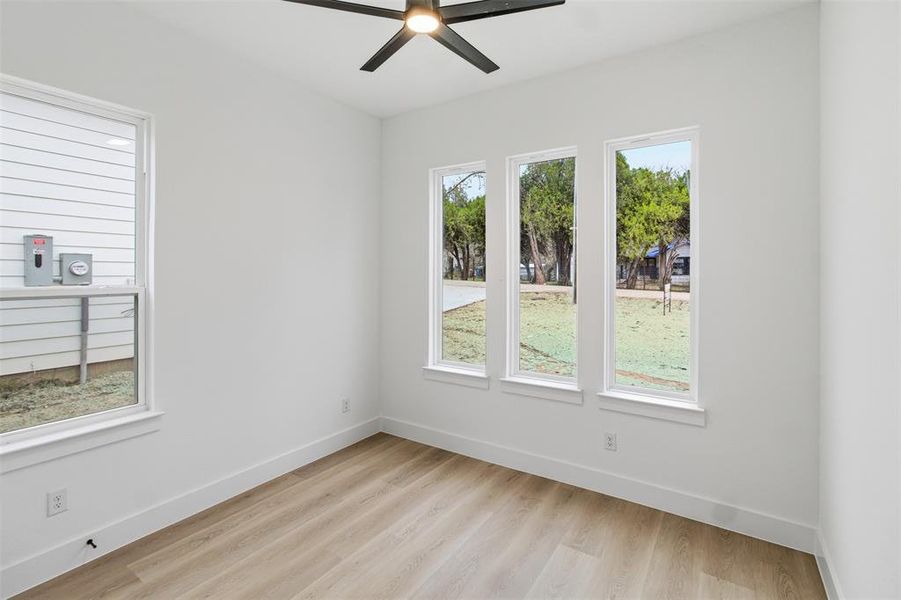 Spare room featuring light wood-style floors and ceiling fan