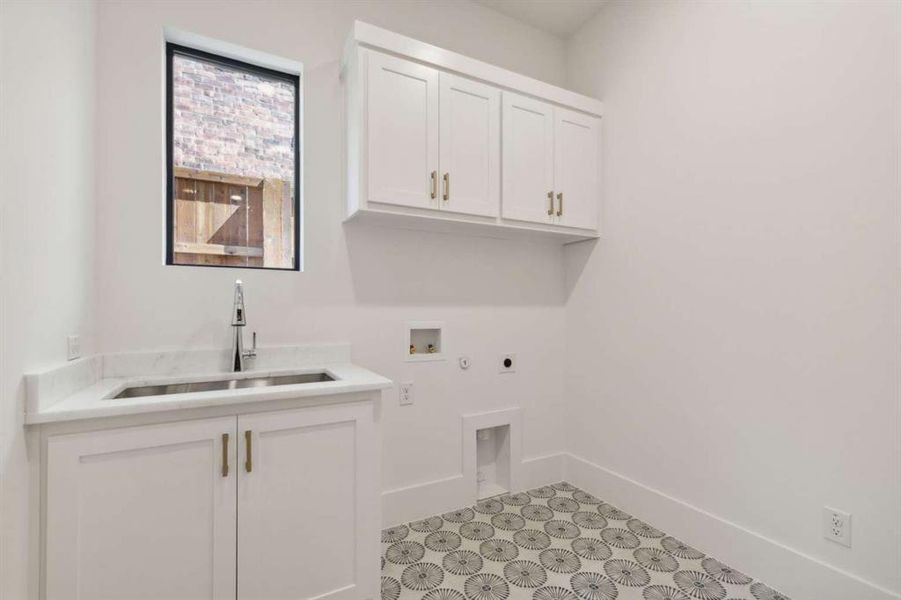 Laundry area featuring washer hookup, cabinets, sink, and electric dryer hookup