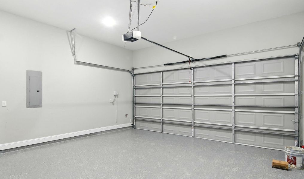 This immaculate two-car garage offers plenty of room for vehicles, tools, and storage. The clean, finished look features epoxy-coated flooring that’s both durable and easy to maintain, making it ideal for a workshop or home gym setup. Bright overhead lighting and freshly painted walls create a crisp, well-kept space ready for immediate use.Whether you need extra storage or a place to tinker with projects, this garage provides functionality, organization, and style to complement the home’s modern appeal. This immaculate two-car garage offers plenty of room for vehicles, tools, and storage. The clean, finished look features epoxy-coated flooring that’s both durable and easy to maintain, making it ideal for a workshop or home gym setup. Bright overhead lighting and freshly painted walls create a crisp, well-kept space ready for immediate use.Whether you need extra storage or a place to tinker with projects, this garage provides functionality, organization, and style to complement the home’s modern appeal.