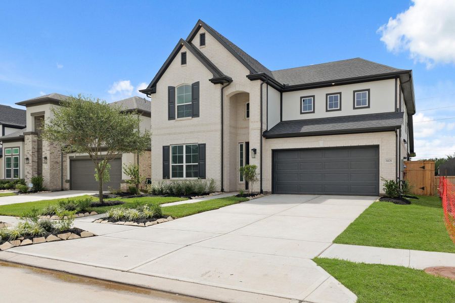 Front exterior of a new home in Sienna Village of Anderson Springs 50', Missouri City, TX, highlighting curb appeal (Image 12). Front exterior of a new home in Sienna Village of Anderson Springs 50', Missouri City, TX, highlighting curb appeal (Image 12).