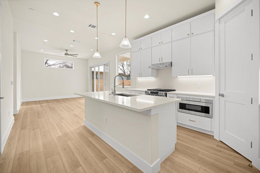 Kitchen/living combo. Modern appliances include a gas range, dishwasher, and a Microwave drawer.