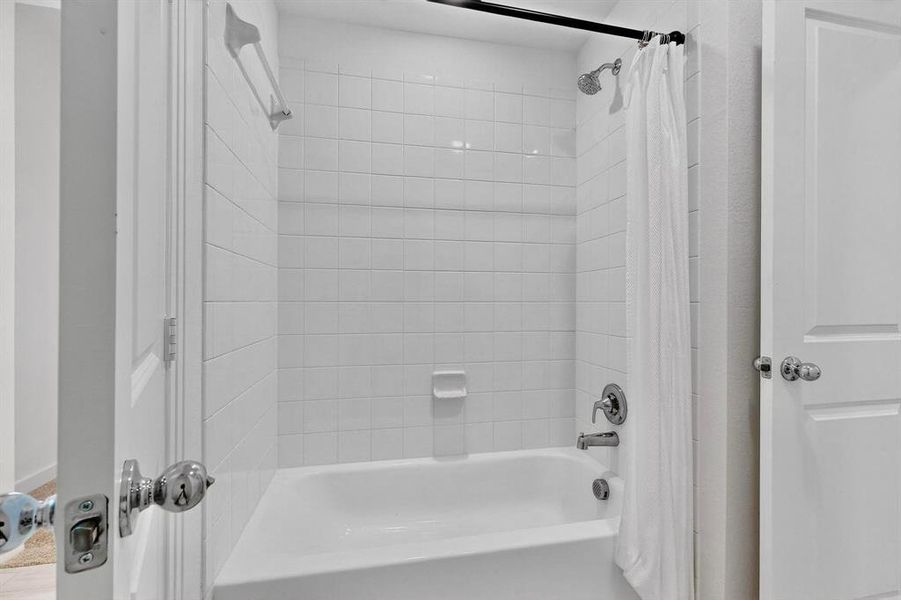Bathroom with shower / bath combo with shower curtain Bathroom with shower / bath combo with shower curtain
