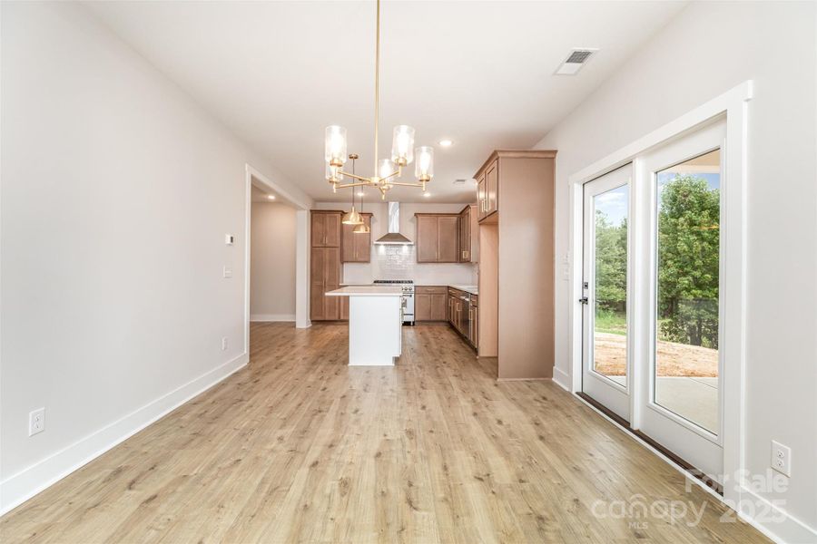 Dining to back patio and kitchen Dining to back patio and kitchen