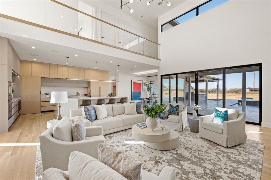 Open-concept living area connecting seamlessly to dining and kitchen spaces. Open-concept living area connecting seamlessly to dining and kitchen spaces.