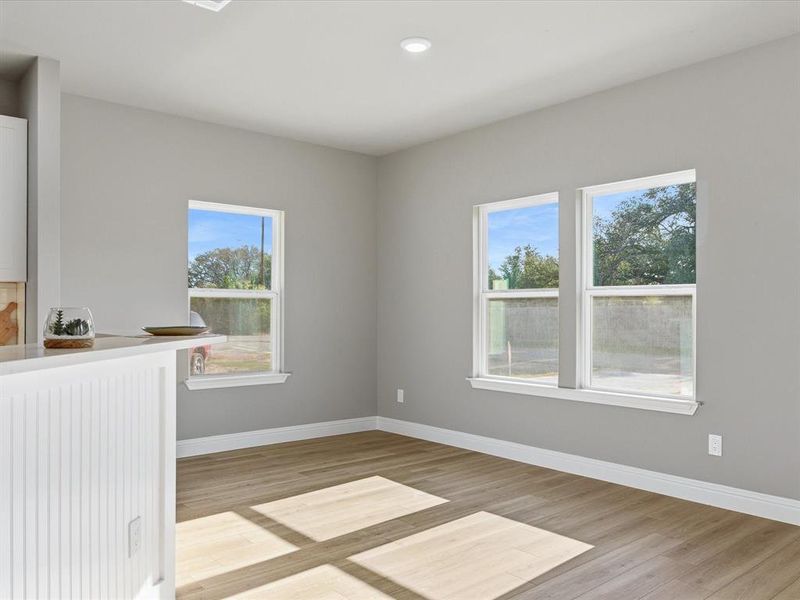 Unfurnished room featuring light wood-style flooring, healthy amount of natural light, and recessed lighting Unfurnished room featuring light wood-style flooring, healthy amount of natural light, and recessed lighting