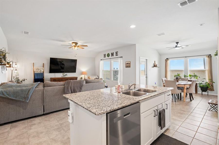 Kitchen featuring ceiling fan, white cabinets, open floor plan, recessed lighting, and vaulted ceiling