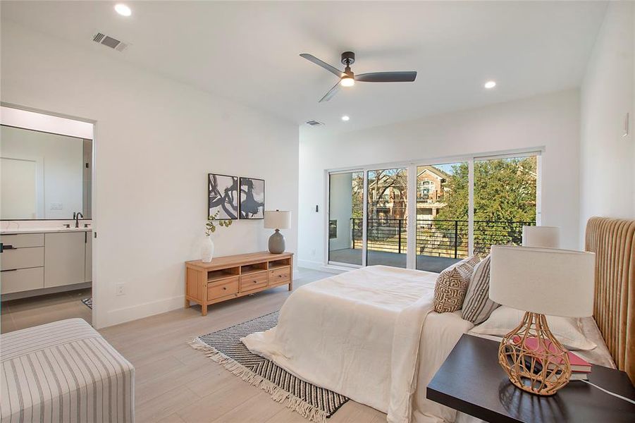 Bedroom featuring access to outside, sink, ensuite bath, ceiling fan, and light wood-type flooring