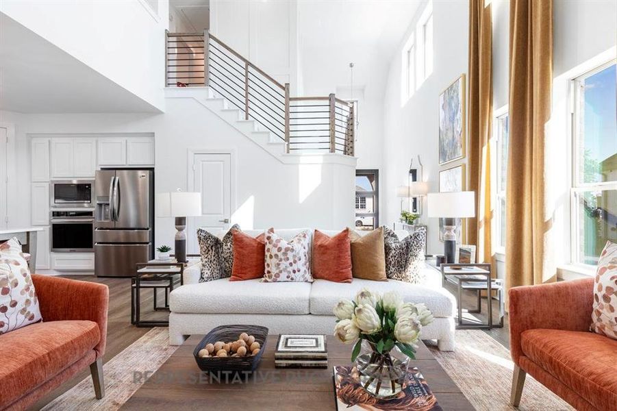 Living room with a high ceiling and wood finished floors