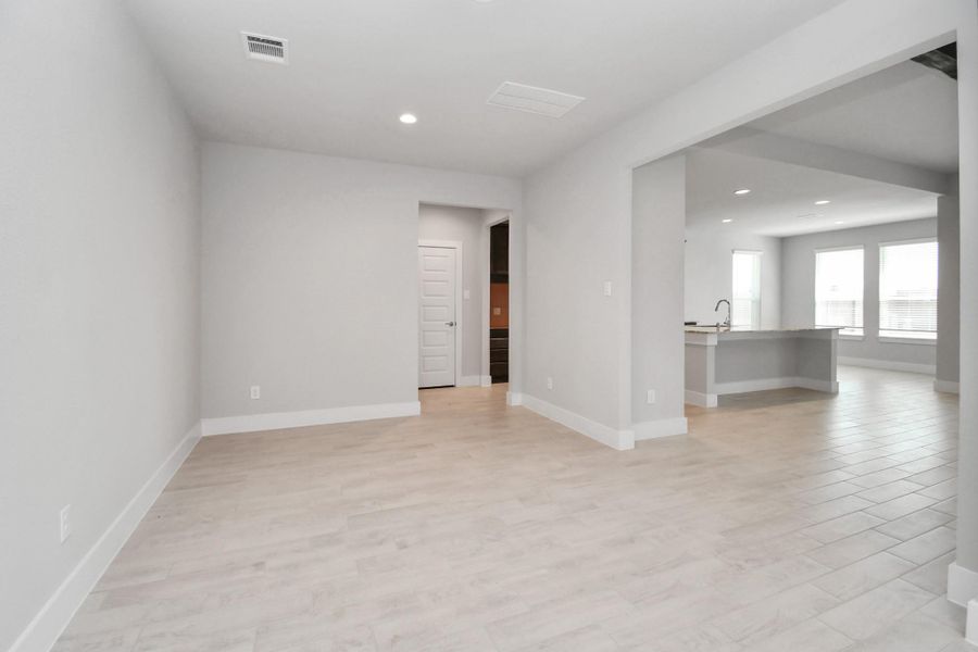Create lasting memories with your family and friends at the dining table! This expansive dining room showcases sophisticated flooring, custom paint, and seamlessly connects to the family room and kitchen, providing an open and inviting atmosphere. Sample photo of completed home with similar floor plan. Actual colors and selections may vary. Create lasting memories with your family and friends at the dining table! This expansive dining room showcases sophisticated flooring, custom paint, and seamlessly connects to the family room and kitchen, providing an open and inviting atmosphere. Sample photo of completed home with similar floor plan. Actual colors and selections may vary.